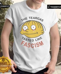 Official Ralph Wiggum 'The Teargas Tastes Like Fascism' T-Shirt featuring bold graphics and vibrant colors, perfect for fans.