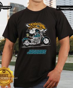 Alt Text: Official Snoopy and Woodstock driving motorbike on Jacksonville Jaguars T-Shirt design for fans.