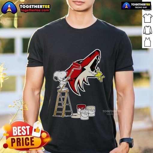 Alt Text: Official Snoopy and Woodstock painting on Arizona Coyotes logo T-shirt, perfect for fans and collectors.