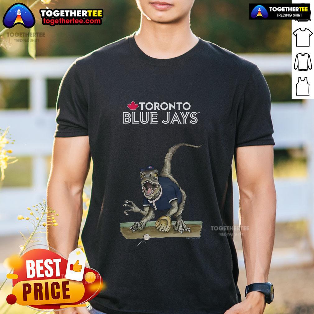 Official Toronto Blue Jays Tiny Turnip Velociraptor T Shirt Official Toronto Blue Jays Tiny Turnip Velociraptor T-Shirt featuring a fun dinosaur design for young baseball fans.