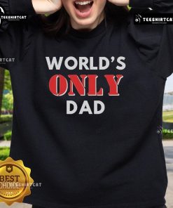 Official World's Only Dad Sweatshirt displayed on a wooden table, featuring a fun design perfect for Father's Day gifts.