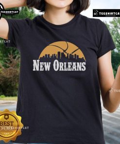 Alt Text: Premium New Orleans Pelicans cityscape skyline style 2025 ladies tee featuring vibrant team colors and design.