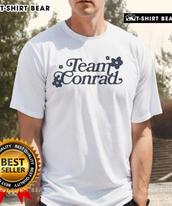 Pretty Team Conrad T-Shirt featuring a stylish design, perfect for fans of the popular series and comfortable everyday wear.
