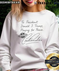 Donald Trump in a 'Pretty To President' sweatshirt featuring Cristiano Ronaldo, promoting peace and unity.