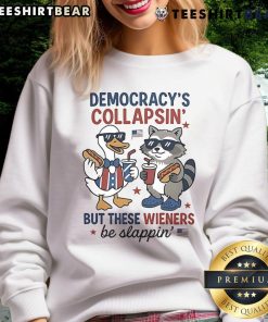 Alt Text: Top Duck and Raccoon Democrat Fourth of July shirt featuring 'Democracy's Collapsing, But These Wieners Be Slapping' design.