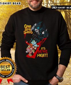 Cozy 'Top Grab Some Snacks It's Movie Night' sweatshirt featuring fun typography, perfect for comfortable movie nights.
