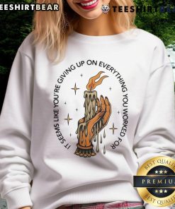 Candle sweatshirt featuring the phrase 'Top It Seems Like You're Giving Up on Everything You Worked For' in cozy setting.