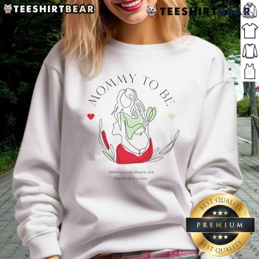 Top Mommy To Be Growing A Tiny Miracle Sweatshirt in soft fabric, perfect for celebrating pregnancy with style.
