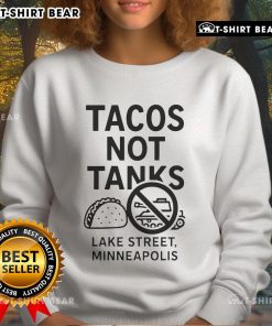 Cozy sweatshirt featuring Top Tacos Not Tanks design, perfect for Minneapolis street style enthusiasts.