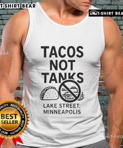 Top Tacos Not Tanks tank top displayed on Lake Street in Minneapolis, featuring vibrant taco-themed design.