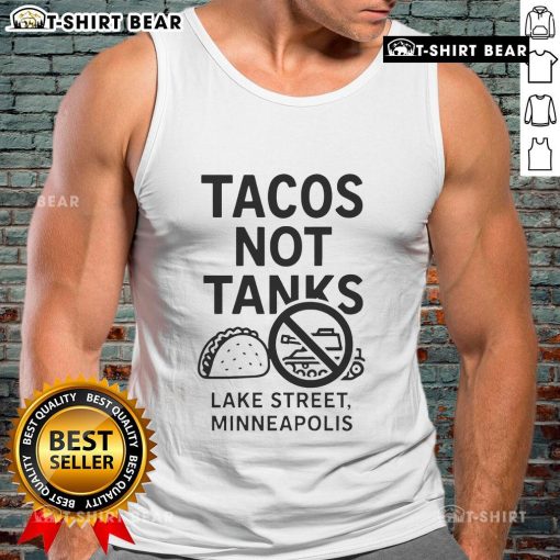 Top Tacos Not Tanks tank top displayed on Lake Street in Minneapolis, featuring vibrant taco-themed design.
