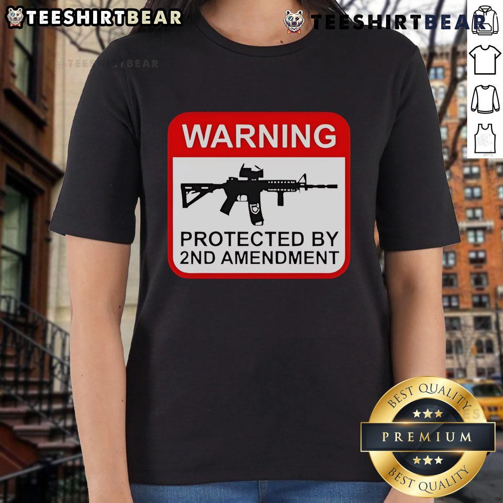 Top Warning Protected By 2Nd Amendment Ladies Tee Alt Text: Top warning graphic on a 2nd Amendment ladies tee, promoting gun rights and women's empowerment in stylish apparel.