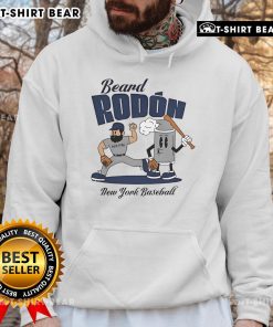 Carlos Rodon in a New York Yankees hoodie showcasing his beard during mid-summer baseball practice.