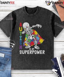 Alt Text: Awesome dabbing skeleton wearing an autism awareness puzzle cape on a washed t-shirt, showcasing superpower spirit.