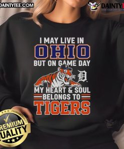 Cozy sweatshirt reads 'I May Live In Ohio But On Game Day My Heart Belongs To The Detroit Tigers' in bold lettering.