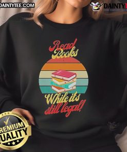 Vintage sunset sweatshirt featuring 'Awesome Read Books While It's Still Legal' design for book lovers.