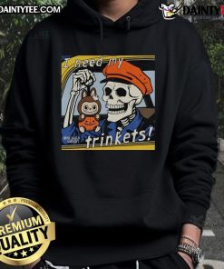 Alt Text: Awesome skeleton holding a Labubu plush, wearing an I Need My Trinkets hoodie, perfect for quirky fashion lovers.