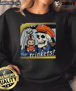 Alt Text: Awesome skeleton holding 'Labubu I Need My Trinkets' sweatshirt, showcasing a fun and quirky Halloween fashion statement.