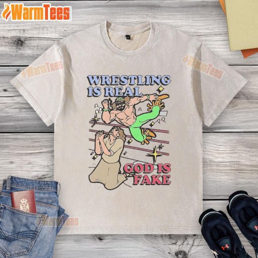 Awesome wrestling is real God is fake washed t-shirt displayed on a hanger, perfect for wrestling fans and casual wear.