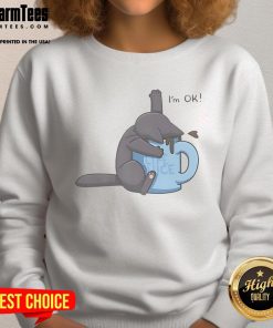 Alt Text: Cute cat drowning in a coffee cup on a cozy sweatshirt, featuring the phrase 'I'm OK' for cat lovers.