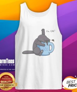 Cute cat playfully submerged in a coffee cup, wearing an I'm OK tank top, showcasing quirky pet humor.