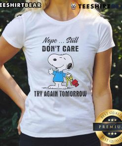 Alt Text: Cute Snoopy graphic on a ladies tee with 'Nope, still don't care, try again tomorrow' text design.