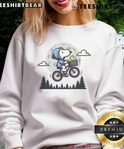 Cute Snoopy and Woodstock fly to the moon on a cozy sweatshirt, perfect for Peanuts fans and casual wear.
