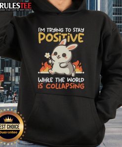 Funny bunny hoodie with 'Trying to Stay Positive While the World is Collapsing' design, perfect for casual wear.