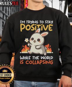 Funny bunny sweatshirt with 'Trying to Stay Positive While the World is Collapsing' design, perfect for casual wear.