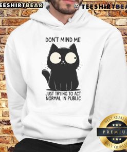 Funny cat in a hoodie, looking quirky and trying to act normal in public, showcasing playful feline antics.