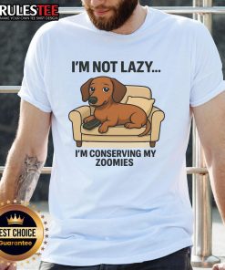Alt Text: Funny dog wearing 'I'M Not Lazy I'M Conserving My Zoomies' T-shirt, showcasing a playful pet attitude and humor.