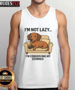 Funny dog wearing a tank top that says I'm not lazy, I'm conserving my zoomies showcases humor and pet fashion.