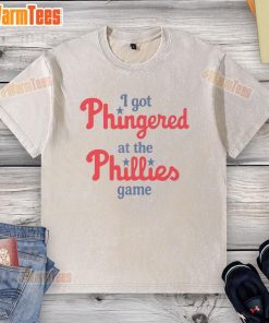 Alt Text: Funny 'I Got Phingered at the Phillies Game' washed t-shirt displayed on a wooden background.
