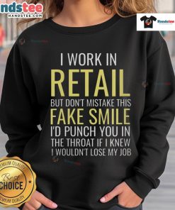 Alt Text: Funny 'I Work In Retail' sweatshirt with fake smile graphic, perfect for retail workers showcasing humor and personality.