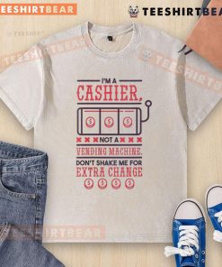 Funny I'm A Cashier Not A Vending Machine t-shirt, humorously warning customers against shaking for extra change.