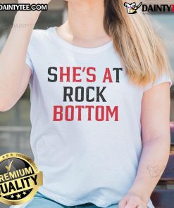 Funny 'She's At Rock Bottom, He's A Bottom' ladies tee showcasing humor and style for confident women.