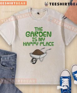 Funny 'The Garden Is My Happy Place' gardening wheelbarrow washed t-shirt displayed on a rustic background.