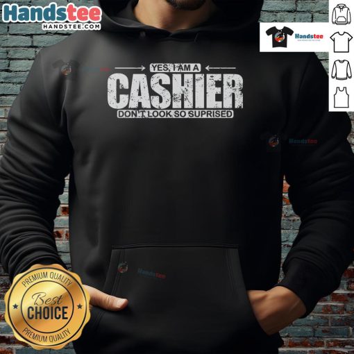 Funny hoodie featuring 'Yes, I Am A Cashier, Don't Look So Surprised' text, perfect for casual wear and humor lovers.