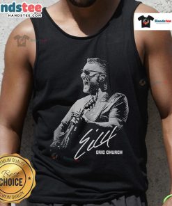 Eric Church performing at Red Rocks Amphitheater in a tank top, showcasing a lively concert atmosphere.