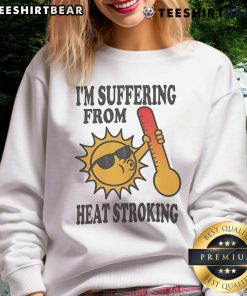 Person wearing 'Good I'm Suffering From Heat' sweatshirt, sweating under the sun, showcasing summer heat struggle.