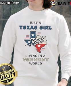 Cozy 'Good Just A Texas Girl Living In A Vermont World' sweatshirt displayed on a rustic wooden background.