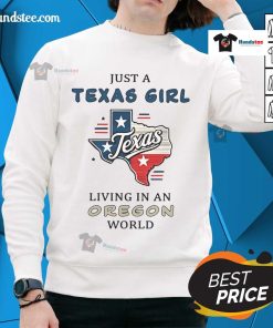 Alt Text: Cozy 'Good Just A Texas Girl Living In An Oregon World' sweatshirt displayed on a rustic wooden background.