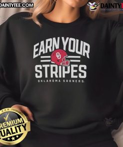 Good Oklahoma Sooners Earn Your Stripes sweatshirt featuring team colors and logo, perfect for fans and game day wear.