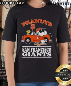 Good San Francisco Giants fan posing with peanuts next to a car, showcasing the Ladies Tee in vibrant colors.