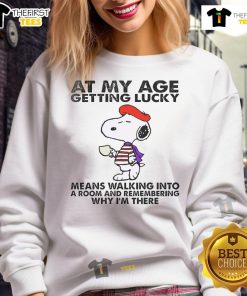 Alt Text: Good Snoopy sweatshirt featuring a humorous quote about aging and luck, perfect for casual wear.