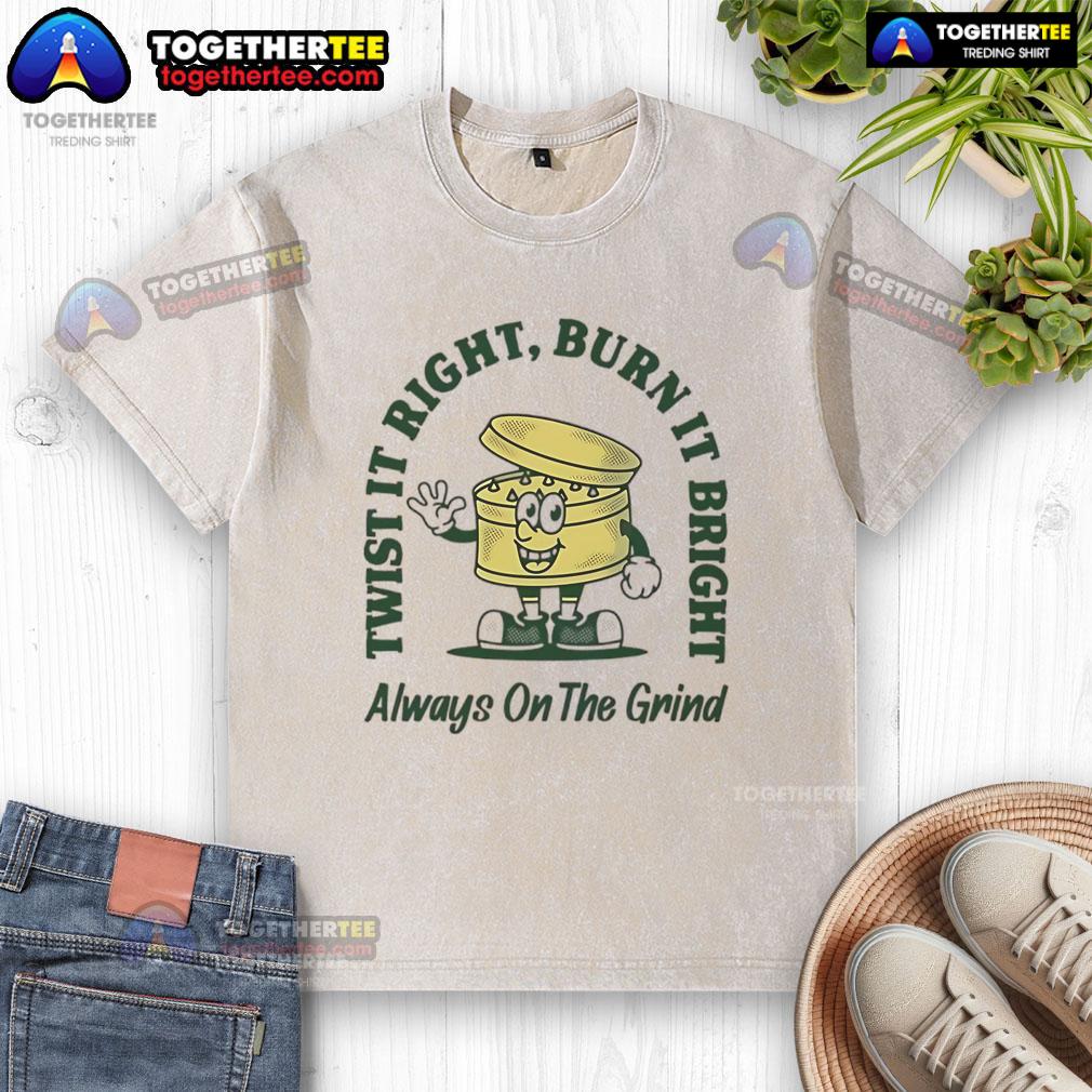 Good Twist It Right Burn It Bright Always On The Grind Washed T Shirt Good Twist It Right Burn It Bright Always On The Grind washed t-shirt displayed on a wooden background.
