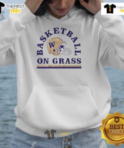 Alt Text: Washington Huskies football helmet and basketball hoodie on grass, showcasing team spirit and athletic gear.