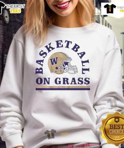 Alt Text: Washington Huskies football and basketball sweatshirt on grass with a helmet, showcasing team spirit and sportswear style.