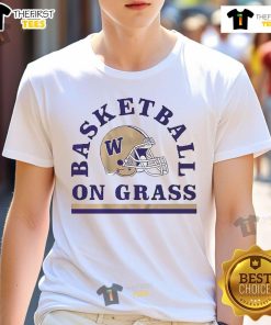 Alt Text: Washington Huskies football helmet t-shirt displayed on grass, showcasing team spirit and athletic style.