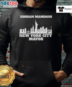 Good Zohran Mamdani wearing a New York City Mayor hoodie, showcasing his candidacy and style in a vibrant urban setting.